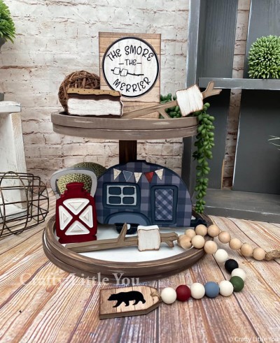 Unfinished kit measures 5” tall on the Camper and includes wooden MDF” 
•1 camper with grooved door and windows 
•1 lantern with grooves 
•2 marshmallows on sticks 
•1 S’more
•1 sign with black vinyl 

