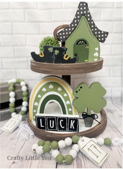 Unfinished kit measures apx. 6.25" tall on house and includes: 
* 1 house with door overlay
* 2 boots
* 1 rainbow
* 1 luck sign
* 1 shamrock
* Black vinyl (some is stencil) 