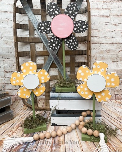 Unfinished kit measures apx. 7" on the tallest flower and includes wooden MDF: 
* 3 flowers with overlays (flower will have a drilled hole in the bottom for dowel)
* 1 dowel @ 7.75" long
* 2 dowels @ 6.25" long
* 3 bases
