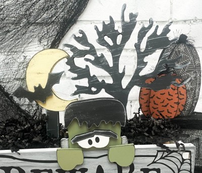 Unfinished kit measures apx. 11" tall on the tree and includes wooden MDF:
* Frankenstein main piece
* 1 hair overlay
* 1 eyes overlay
* 2 hands
* 1 spooky tree
* 1 moon on stand
* 1 bat overlay
* 2 bases
* Black vinyl for eyes