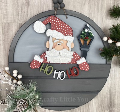 Unfinished kit measures apx. 7.25" tall and includes wooden MDF:
* 1 Santa main piece
* 1 hat brim, face, and beard overlay
* 1 mustache overlay
* 2 hand overlays
* 2 eyebrows
* 1 lamp post
* 3 "Ho Ho Ho" words
* 2 pieces Velcro 

** The Front Door Circle main piece is sold separately.  This price is for the change-out kit only.**