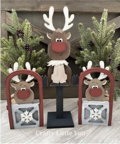 Unfinished kit measures apx. 11.75" tall on the center reindeer and includes wooden MDF:
* 1 reindeer on stand
* 1 base
* 2 sitting reindeer with grooved stable gates
* 1 fur collar overlay
* 1 body and legs overlay
* 2 hoof overlays
* 3 nose overlays (1 larger and 2 smaller)
* 2 snowflake overlays 
* Vinyl eyes, eyebrows, and mouths