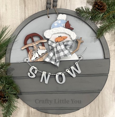 Unfinished kit measures apx. 7.25" tall and includes wooden MDF:
* 1 snowman with attached sled
* 1 carrot nose overlay
* 1 hat brim overlay
* 1 cardinal overlay
* 1 stick arm overlay
* 2 ice skates
* SNOW letters
* Vinyl eyes
* 2 pieces Velcro