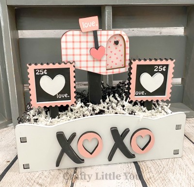 Unfinished kit measures apx. 10" tall and includes wooden MDF: 
* 1 mailbox on stand with front overlay
* 1 heart flag for mailbox
* 2 postage stamps on stands
* 2 scalloped edge overlays
* 2 heart overlays for stamps
* 1 small heart for mailbox handle
* 3 bases
* White vinyl 

**Interchangeable crate sold separately. 