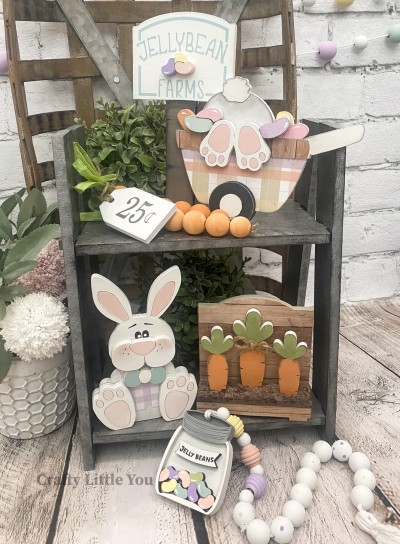 Unfinished kit measures apx. 7.5" tall on the sign and 6.5" on the bunny, and includes wooden MDF:
* 1 Jellybean Farms sign with jellybeans overlay
* 1 bunny in wheelbarrow with feet, jellybean, and tire overlays
* 1 sitting bunny
* 1 cheeks and nose overlay
* 1 bow-tie overlay
* 2 feet overlays (1 right, 1 left)
* 1 carrot stand
* 3 carrots
* Black vinyl (some is stencil)
* 16 total pieces