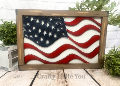Unfinished kit measures 12"x18" and includes wooden MDF: 
* Back piece
* Frame
* 1 waving rectangle wood overlay with cut-out stars
* 5 waving stripe wood overlays (3 short, 2 long) 