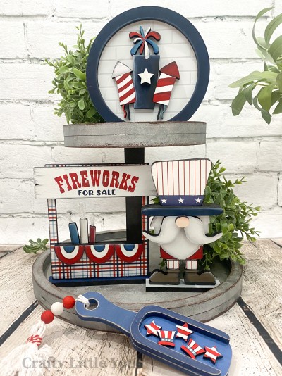 Unfinished kit measures apx. 6" tall and on the firework framed circle and includes wooden MDF:
* 1 circle main piece
* 1 circle frame overlay
* 3 connected fireworks overlay
* 1 star overlay
* 1 firework stand main piece
* 1 fireworks sign overlay
* 3 connected buntings overlay
* 1 base for firework stand
* 1 Uncle Sam main piece
* 1 hat brim and mustache connected overlay
* 1 nose overlay
* 1 Uncle Sam base
* Vinyl stencil