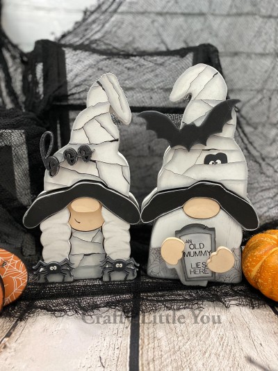 Unfinished kit includes wooden MDF:
*2 hats with engraved mummy wrap lines
*2 hat brims
*1 dress with engraved mummy wrap lines
*1 gravestone with engraved lettering
*1 “boo” cursive wood word overlay
*1 bat overlay
*2 spider hair-tie overlays
*10 dot Velcros