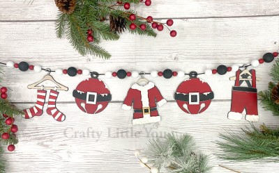Unfinished kit measures apx. 5.5" on the clothing pieces, and includes wooden MDF:
*1 set of Santa’s socks on hanger
*1 Santa coat on hanger
*1 Santa coat fur and belt overlay piece
*1 pair of Santa pants on hanger
*2 jingle bells
*2 jingle bell belt and buckle overlay pieces
