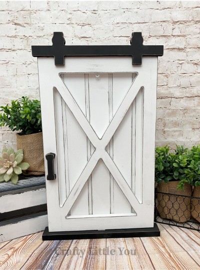 Unfinished kit measures apx. 9.75"x16" and includes wooden MDF: 
* 1 grooved back piece and cross overlay
* 1 hanging hardware
* 1 door handle
* 1 base
* 1 eyescrew
