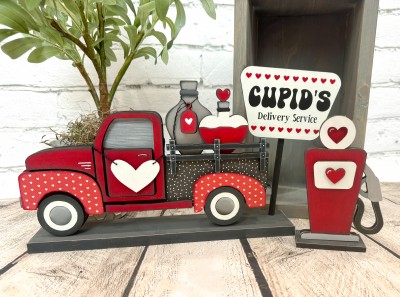 Unfinished kit measures apx. 6" on the gas meter and includes wooden MDF:
*2 love potion bottles
*1 hanging tag for love potion bottle
*1 hanging heart
*1 gas meter main piece
*1 gas meter front overlay
*1 gas meter front panel overlay
*1 base
*1 Cupid’s Delivery Service sign
*1 dowel
*Black vinyl (hearts are stencil)