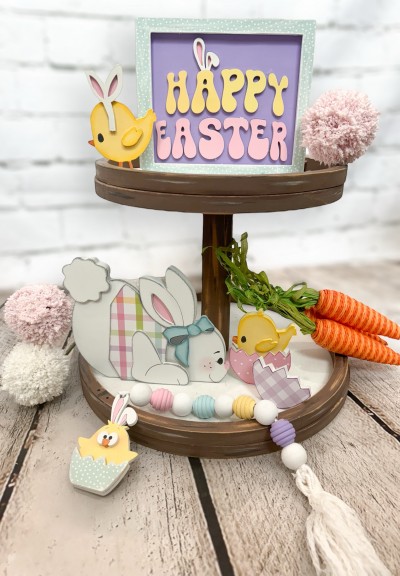 Unfinished kit measures apx. 5" tall on the bunny and includes wooden MDF:
*1 sign with frame
*1 set of “HAPPY EASTER” wood letters
*1 standing chick with base
*1 bunny ears with headband overlay
*1 bunny
*1 vest
*1 leg overlay
*1 tail overlay
*1 set of ears
*1 bow
*1 chick with egg shell overlay
*2 chick wing overlays
*1 eggshell