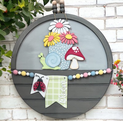 Unfinished kit measures apx. 7.25" tall and includes wooden MDF:
*1 flower pot main base piece
*3 flower overlays
*3 flower center overlay
*1 snail overlay
*1 snail shell overlay
*2 mushroom cap overlays
*1 large hanging tag
*1 small hanging tag
*1 set of “Bloom” wood word overlays
*1 ladybug
*2 ladybug wing overlays
*2 pieces Velcro