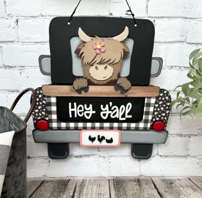 Unfinished kit pieces made to fit the Hanging Truck 2.0 and include wooden MDF:
*1 truck cab overlay
*2 fender overlays
*1 tail gate overlay
*1 license plate
*1 tailgate panel with attached cow
*1 cow hair overlay
*1 cow nose overlay
*2 cow hooves
*1 flower and center overlay
*1 set of “Hey Y’all” wood letters
*3 chicken overlays
*6 pieces square Velcro