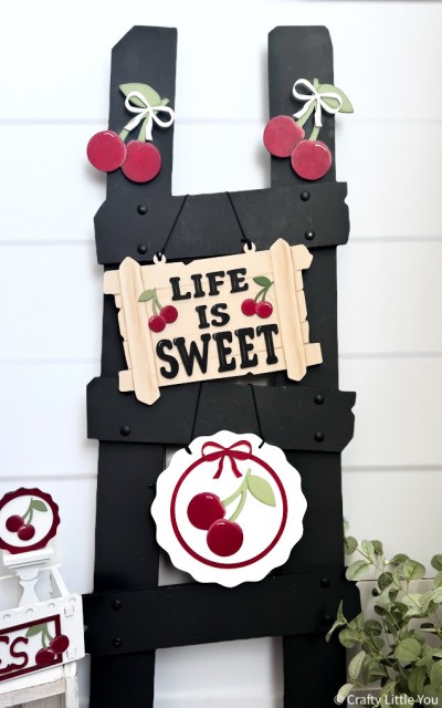 Unfinished kit measures 9" tall on circle Cherry Sign and includes wooden MDF: *1 - circle cherry sign *1 - smaller circle overlay *1 - cherry *1 - sign *1 - “LIFE IS SWEET” lasered word *2 - small cherries *2 - cherries *3 - bows