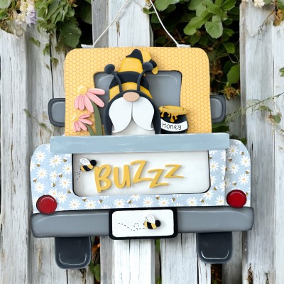 Unfinished kit pieces made to fit the Hanging Truck 2.0 and includes wooden MDF: *1 truck cab overlays *2 fender overlays *1 tailgate overlay  *1  “BUZZZ” wood lasered letters *2 bees *1 tailgate panel with Gnome, honey pot, and flowers *1 beard, nose, hat brim, antennas *1 honey sign *1 dripping honey overlay *6 square Velcro pieces